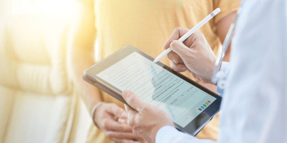 Doctor entering patient data online.